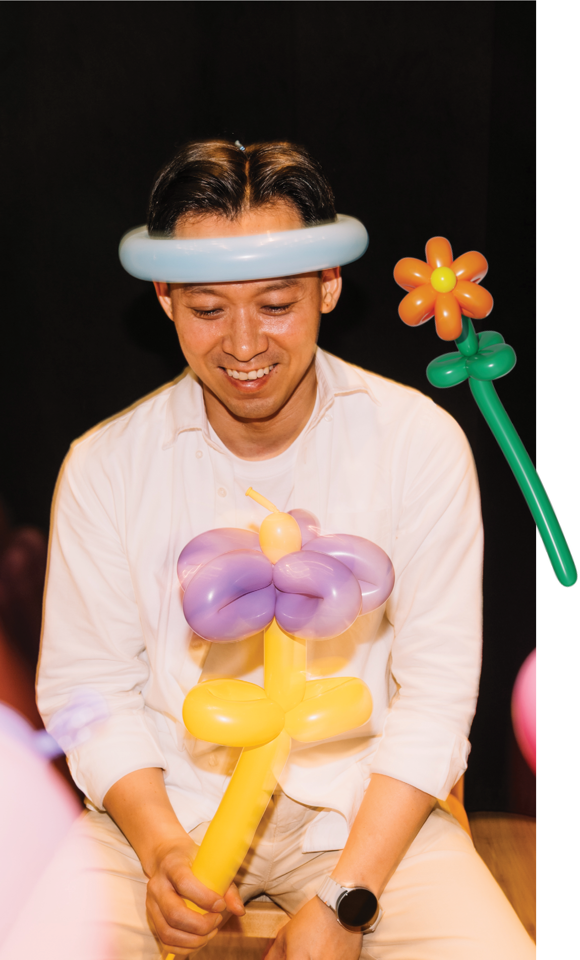 Bing Liang with balloon sculptures at a Hope carnival
